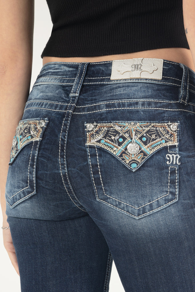 close up of gold and turquoise floral bootcut jeans design