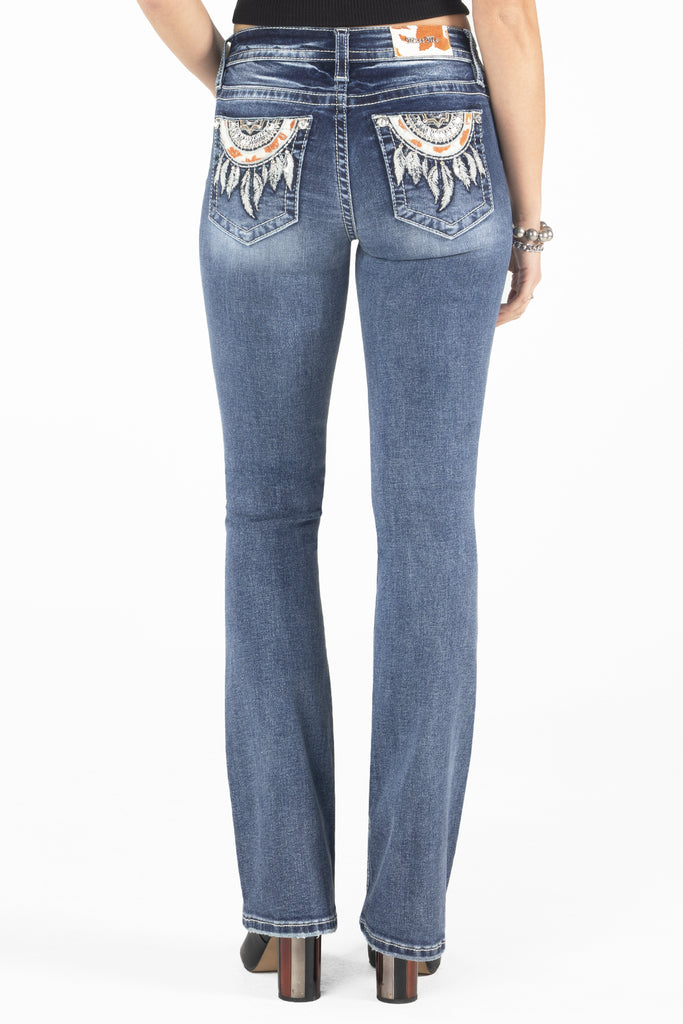 cow printed dreamcatcher on bootcut jeans back pockets