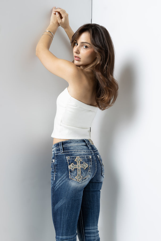 model wearing aztec embroidered cross-designed jeans